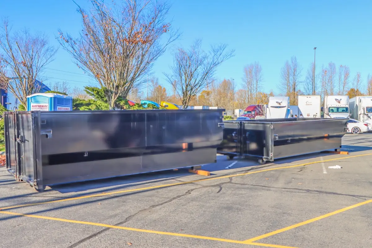 Professional dumpster rental service with roll-off container on residential driveway in Hidden Valley